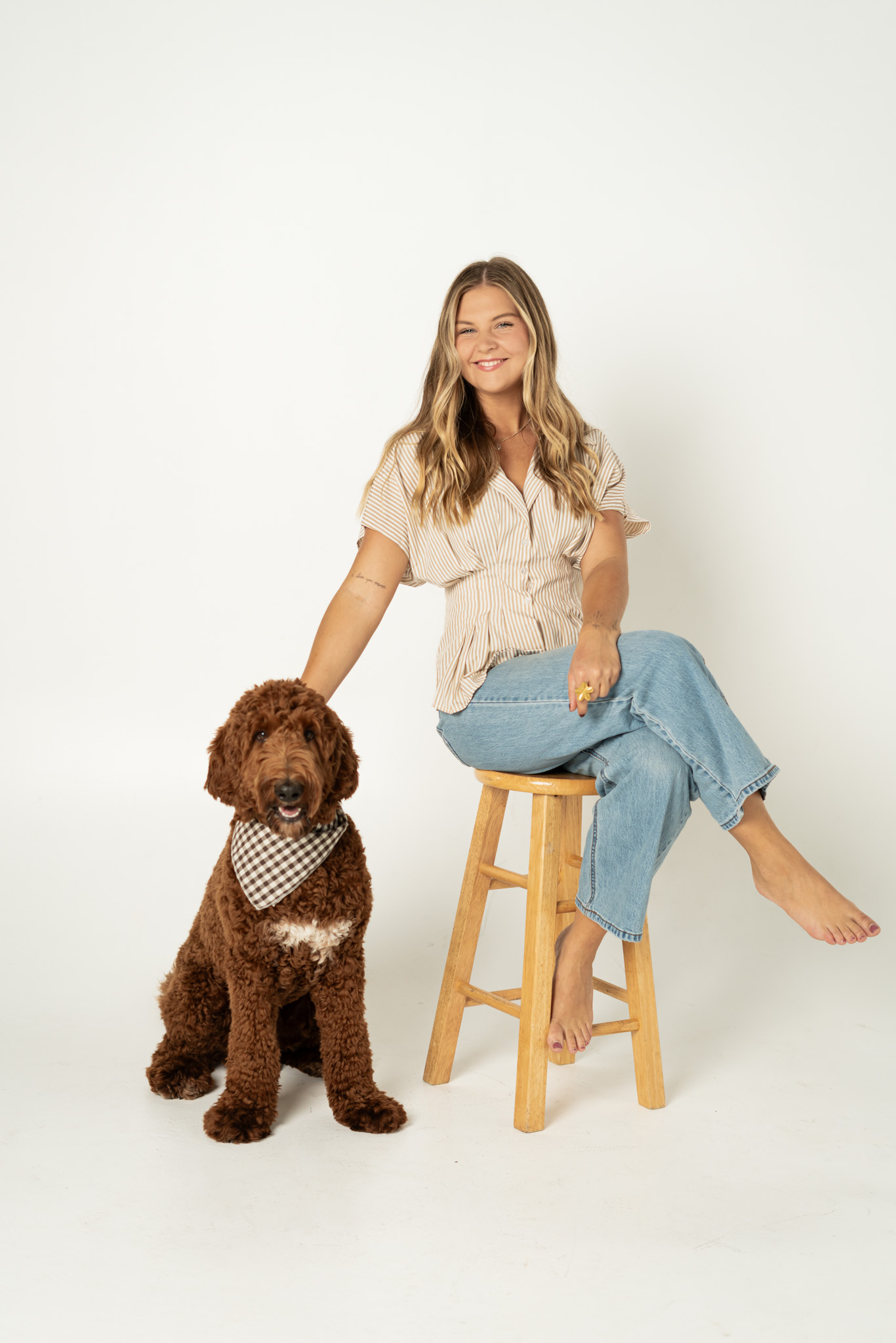 Benson sitting beside his person on a stool